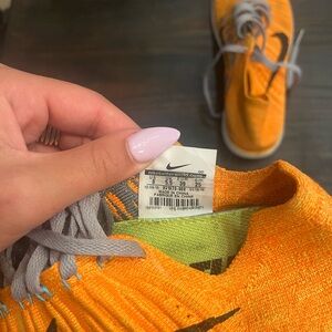 Nike RN Flyknit Bright Orange Athletic Shoes.